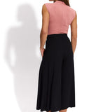 Różowa bezrękawnikowa bluzka i czarne spodnie typu culottes – elegancka stylizacja damska z precyzyjnym krojem